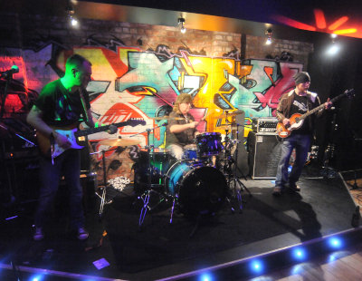 Devils River on stage with colourful lighting viewed from stage left