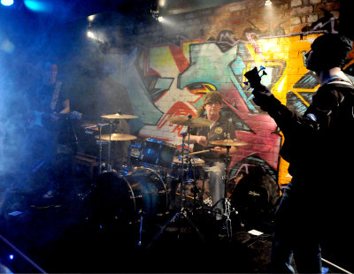 Devils River on stage with colourful lighting and smoke viewed from stage right